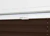 A close-up view of a window blind mechanism. Produktbild-Vorschau