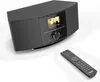 A black digital radio with a remote control on a white background. Produktbild-Vorschau