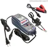 A battery charger and its accessories are laid out on a white background. Voir les images du produit