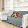 A golden retriever dog is lying on a gray sofa cover on a couch in a living room. Náhled obrázku produktu