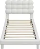 A white upholstered bed frame with a tufted headboard and wooden slats for mattress support, shown from the front. Produktbild-Vorschau