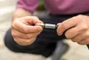 A person is holding and connecting a nozzle to a hose. Produktbild-Vorschau