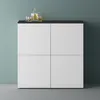 A modern cabinet with a dark top, featuring four white doors. On top of the cabinet are two glasses of amber liquid and a decanter filled with the same liquid. Produktbild-Vorschau
