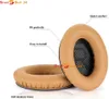 Two tan-colored headphone ear pads are shown on a white background. Text labels point to features of the ear pads. Produktbild-Vorschau