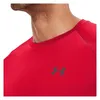 Close-up of a person wearing a red t-shirt with a logo. Náhľad obrázku produktu