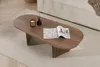 A wooden coffee table with a magazine, candle, and diffuser on it, placed on a rug in a living room. Produktbild-Vorschau