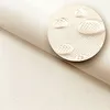 A close-up view of waterproof fabric with water droplets on it, highlighting its texture and water-repellent properties. Voir les images du produit