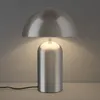 A silver mushroom-shaped table lamp is shown on a light-colored surface against a gray background. Voir les images du produit