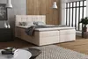 A bedroom scene with a boxspring bed, nightstand, and artwork. Voir les images du produit