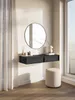 A minimalist vanity setup with a floating desk, round mirror, and stool. Anteprima dell’immagine prodotto