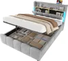 A modern upholstered bed frame with its storage compartments open, revealing neatly folded linens and textiles. The headboard features integrated shelving and lighting. Anteprima dell’immagine prodotto