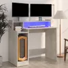 A gaming desk with dual monitors, keyboard, mouse, and a computer tower, set in a room with a floor lamp. Podgląd zdjęcia produktu