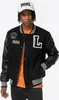 A man wearing a Lonsdale college jacket and a white Lonsdale cap. Produktbild-Vorschau