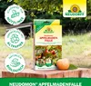 A product box for an apple maggot trap is displayed on a wooden surface with an apple and leaves in the foreground, set against a blurred outdoor background. Produktbild-Vorschau