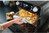 A person is removing a tray of dried fruit from an air fryer oven. Anteprima dell’immagine prodotto