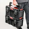 A person is holding a stack of two Qbrick System toolboxes. Náhled obrázku produktu