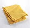 A folded yellow textile product on a white background. Náhled obrázku produktu