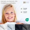 A smiling woman is lying in bed, holding up a white duvet. The image also shows swatches of different colored duvet covers and text advertising "large selection of colors & sizes". Produktbild-Vorschau