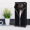 A black fabric wardrobe with clothes hanging inside and teddy bears on a shelf, next to a potted plant. Náhľad obrázku produktu