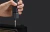 A hand holding a dark gray electric screwdriver with a silver tip, about to screw into a black object, possibly an amplifier or speaker cabinet. Podgląd zdjęcia produktu