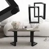 A coffee table with a wood top and black metal legs, placed in a living room setting with a sofa and a rug. Náhľad obrázku produktu