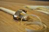 A close-up of a peeler on a wooden cutting board, peeling white asparagus. Anteprima dell’immagine prodotto