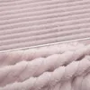 A close-up view of a pink, textured fabric, likely a blanket or throw, showing two different textures. Produktbild-Vorschau
