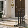 A modern U-shaped stair handrail is installed on the steps of a house entrance. Náhľad obrázku produktu