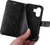 A hand is holding open a black flip phone case, revealing the inside of the case and the phone slot. Produktbild-Vorschau