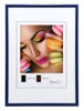 A framed picture of a woman with macarons and makeup. Produktbild-Vorschau