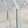 Close-up of a white, grid-patterned greenhouse cover with two green ties. Produktbild-Vorschau