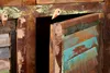 A close-up view of a rustic, multi-colored wooden cabinet with one door ajar. Náhled obrázku produktu