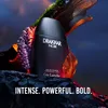 A black bottle of Drakkar Noir cologne is displayed on a rocky surface with natural elements like moss and wood. Náhled obrázku produktu