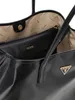 Interior view of a black Guess shopper bag, showing a smaller pouch inside. Produktbild-Vorschau