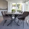 A dining room with a table and chairs. Voir les images du produit