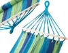Close-up view of a striped hammock with wooden spreader bars and blue rope suspension. Produktbild-Vorschau