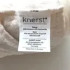 A close-up of a product label showing brand name, material composition, and manufacturer information. Produktbild-Vorschau