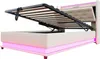 A beige upholstered bed frame with its storage compartment open, revealing wooden slats and a hydraulic lift mechanism. The bed has integrated pink LED lighting along its base and headboard. Náhled obrázku produktu