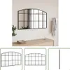 A black arched mirror with a grid pattern hangs on a white wall above a light wood dresser. A folded stack of towels and a diffuser are on the dresser. A scarf hangs on a hook to the right of the mirror. Below the main image are three smaller images showin Produktbild-Vorschau