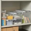 Storage boxes are neatly arranged on a shelf in a cabinet. Produktbild-Vorschau
