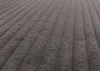 A close-up, angled view of a dark gray corduroy fabric with a ribbed texture. Náhled obrázku produktu