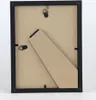 The back of a black picture frame with a stand. Produktbild-Vorschau