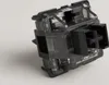 A close-up, studio shot of a black mechanical keyboard switch against a plain white background. Anteprima dell’immagine prodotto
