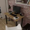 A modern desk setup with a computer, keyboard, mouse, and lamp against a brick wall. Produktbild-Vorschau