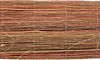 A close-up, horizontal view of a woven mat made of thin, natural branches or reeds, bound together with thin wire and string. Náhľad obrázku produktu