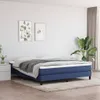 A bedroom scene with a blue boxspring bed, nightstand, and artwork on the wall. Podgląd zdjęcia produktu