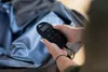 A person is holding a remote control for a spa. Voir les images du produit