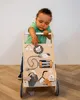 A baby is playing with a wooden activity walker. Produktbild-Vorschau