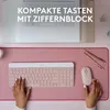 A top-down view of a pink desk setup with a laptop, keyboard, mouse, and pens. Produktbild-Vorschau