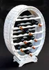 A white wooden wine rack shaped like a barrel, filled with dark wine bottles, is displayed against a black background. Produktbild-Vorschau